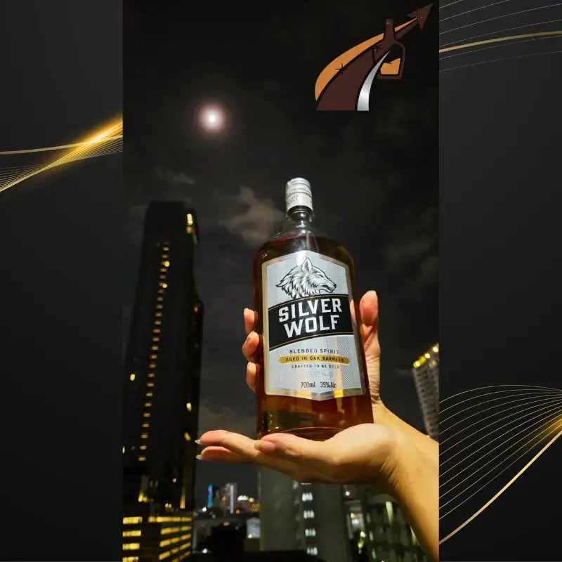Hands holding Silver Wolf Blended Spirit bottle with the background of Bangkok tall buildings, night sky and moon